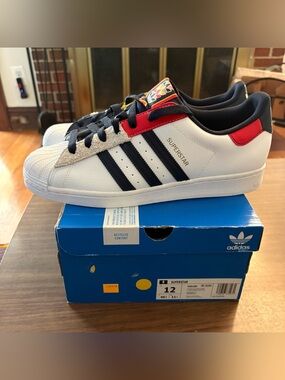 Brand new!  Men’s adidas original Superstar in white, navy & red.  Size 12